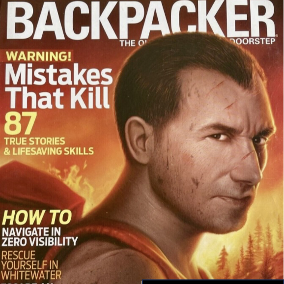 A man is on the cover of backpacker magazine.